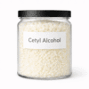 Cetyl Alcohol by Organicsbyjumira — white waxy cosmetic-grade pellets used as an emollient, thickener, and stabilizer in skincare formulations.