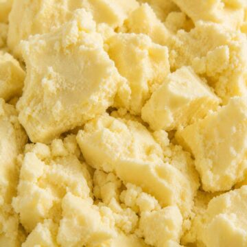 Close-up texture of unrefined shea butter showing natural raw cosmetic butter for skincare formulation in Nigeria